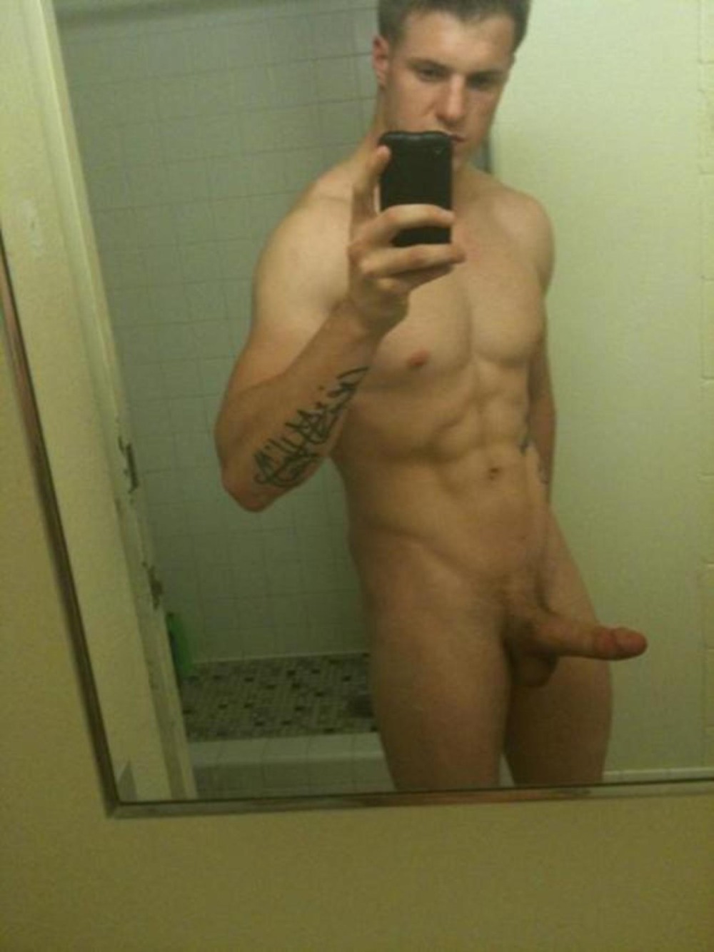Naked guy in front of the mirror