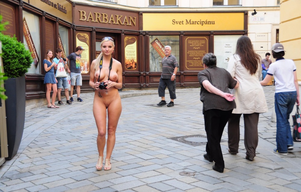 The girl undresses in a public place