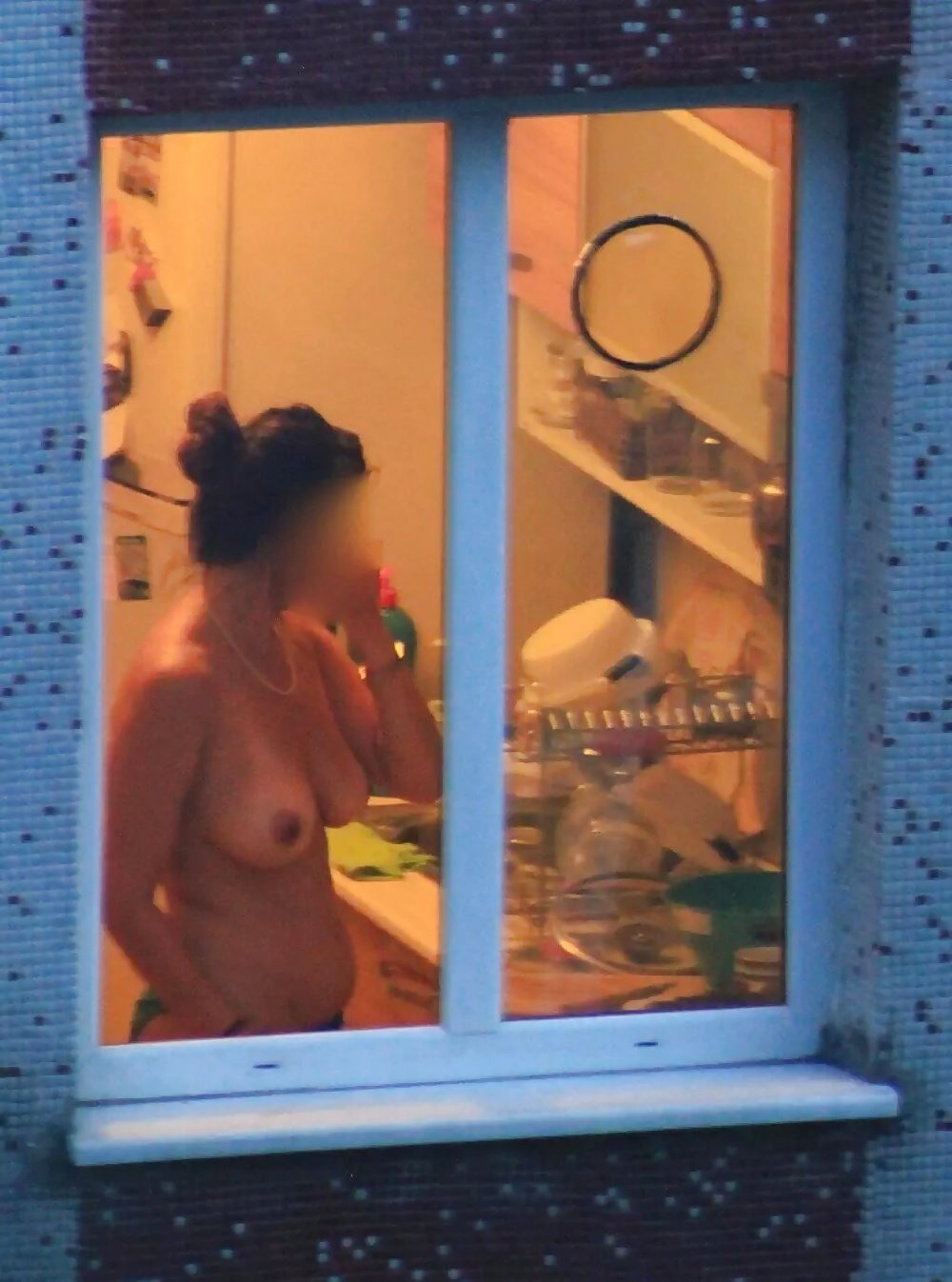 Girl topless on the balcony