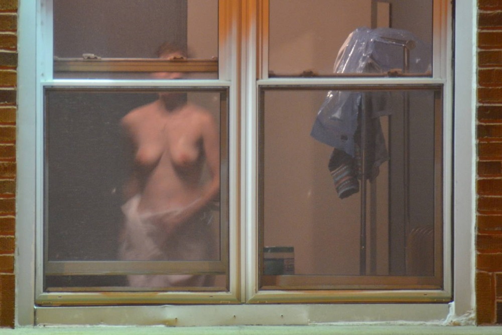 Peeping out the windows behind naked