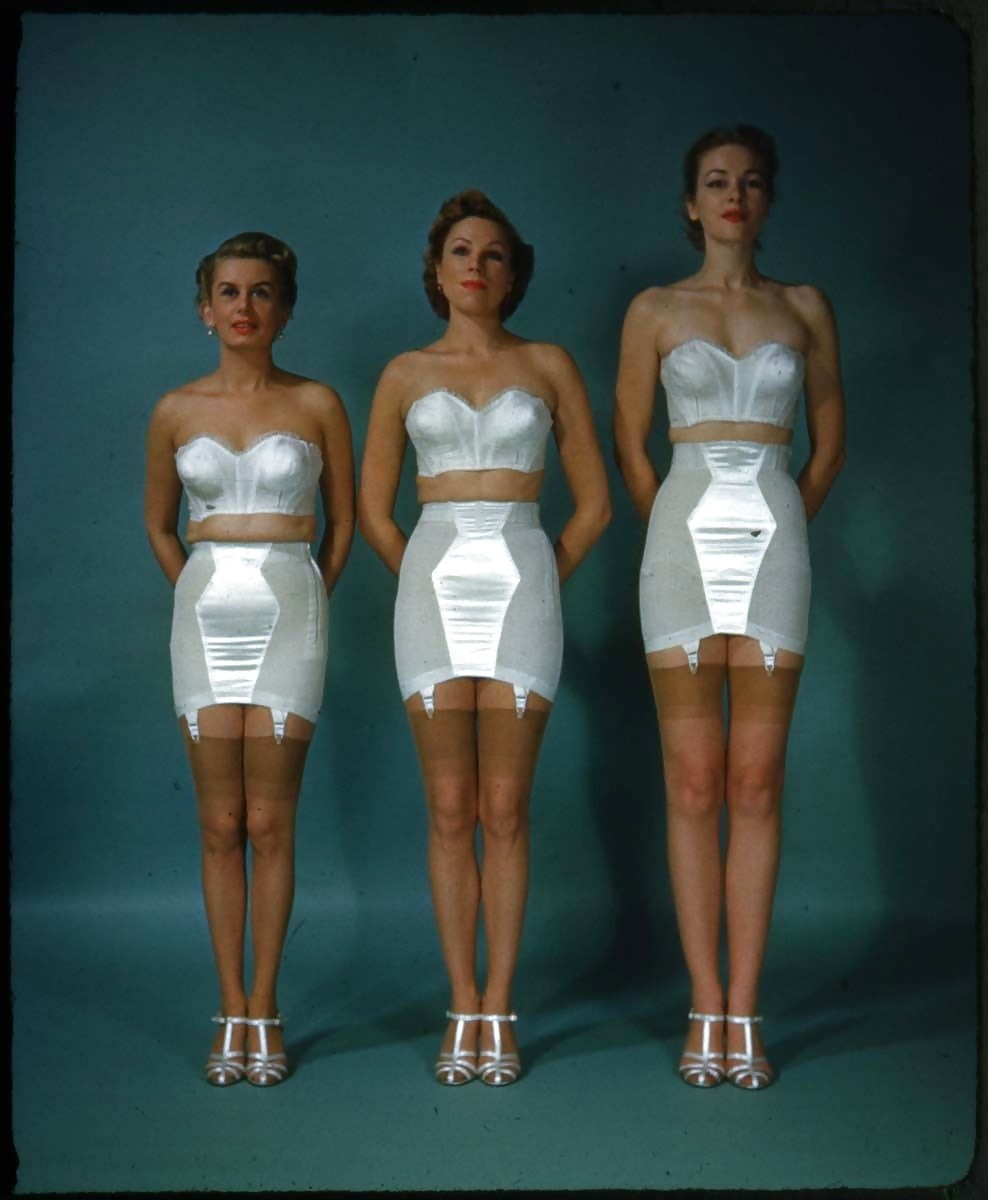 Crossdresser with patch breasts in a corset