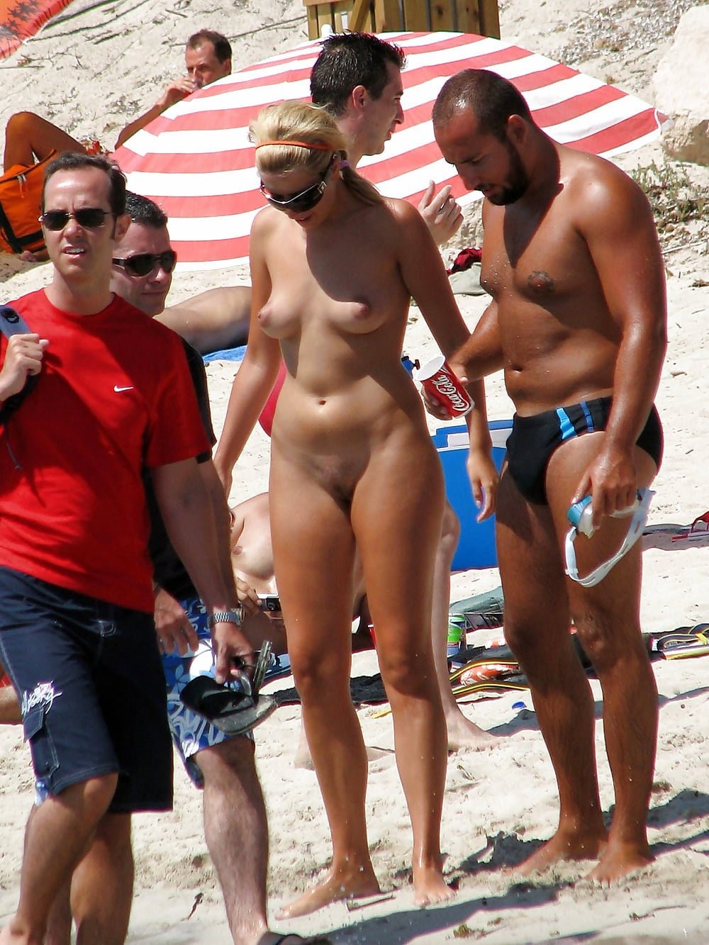 Naked women among those dressed on the beach