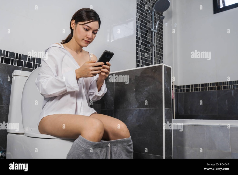 Woman sits on the toilet