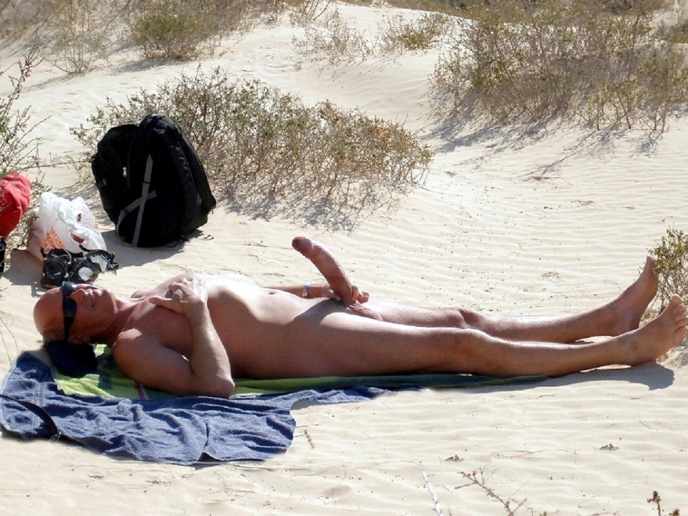 A man with a huge member on the beach