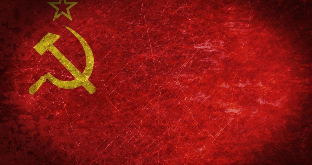 Sickle and hammer on a red background