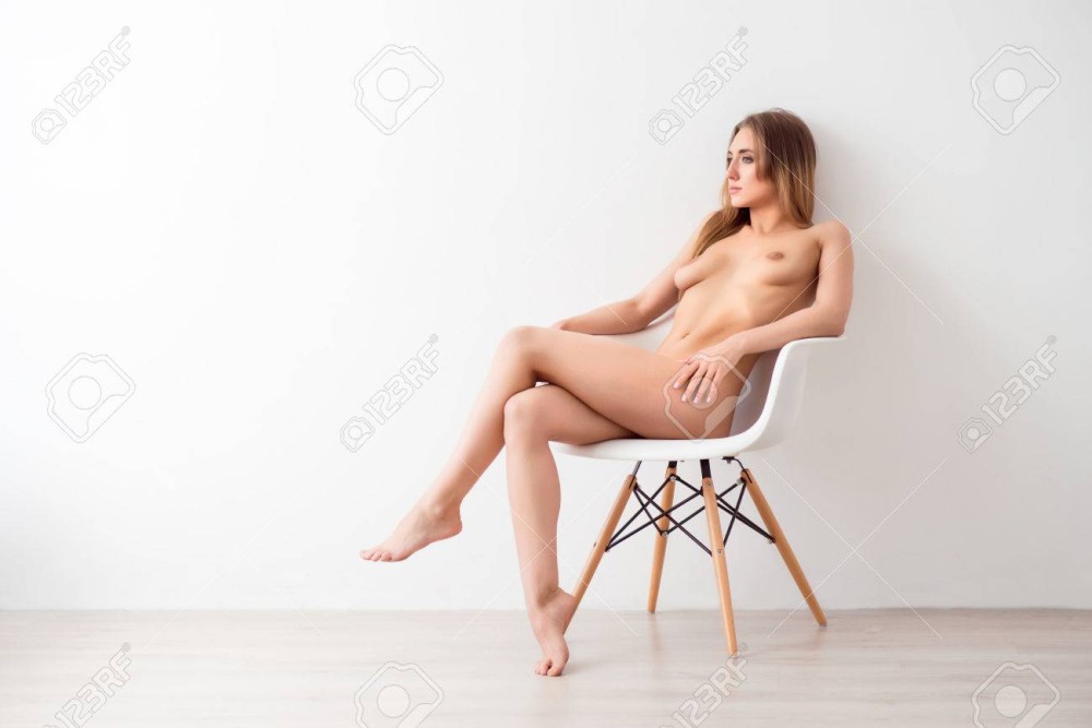 Spread her legs in an armchair